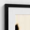 prodigi-GLOBAL-CFPM-20X28-glaze_acrylic _ perspex-frame_classic-papertype_ema-substrateweight_200gsm-mount_2.4mm-mountcolour_snow white-framecolour_black (4) Close-up of the corner of a framed Permission to Rest fine art print with black frame and snow white mount